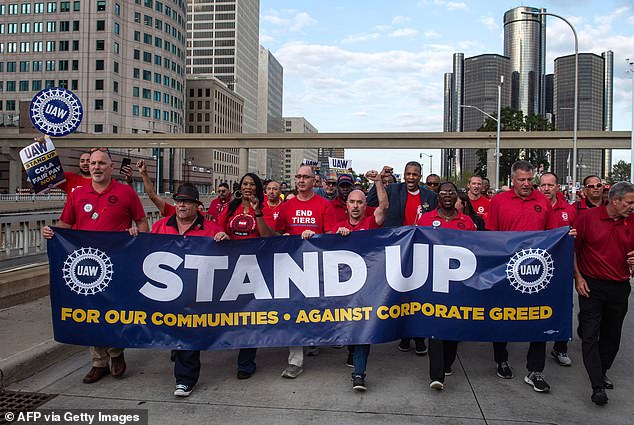 Members of the UAW union march through the streets of downtown Detroit after a rally on the first day of the UAW strike in Detroit
