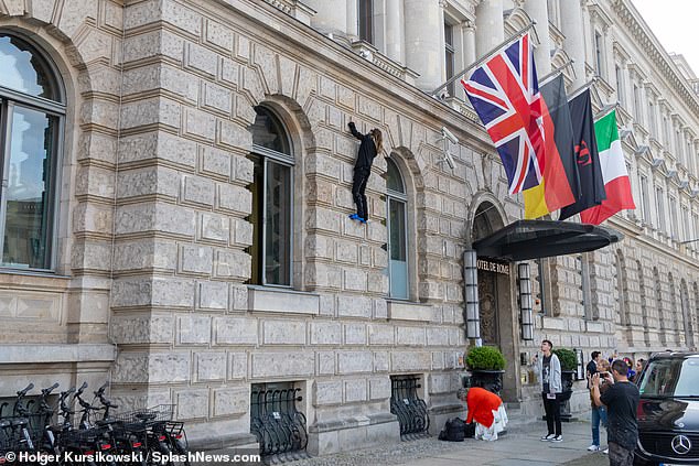 Bizarre: For reasons known only to the Oscar-winning actor and musician, he bravely tried to scale the exterior of the five-star Hotel de Rome