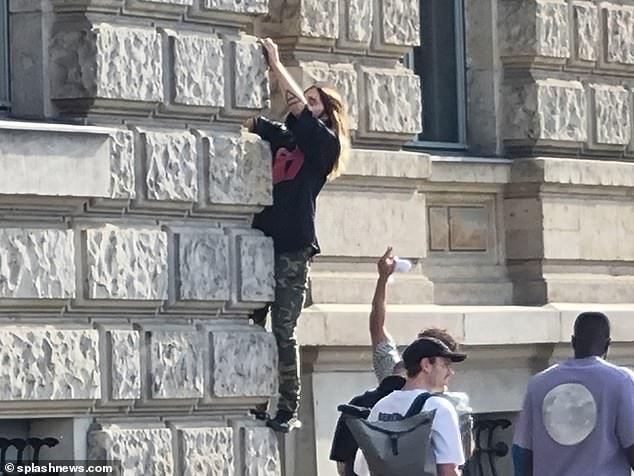 Capital: He was seen outside the Hotel de Rome, where he climbed the wall as spectators watched from the ground