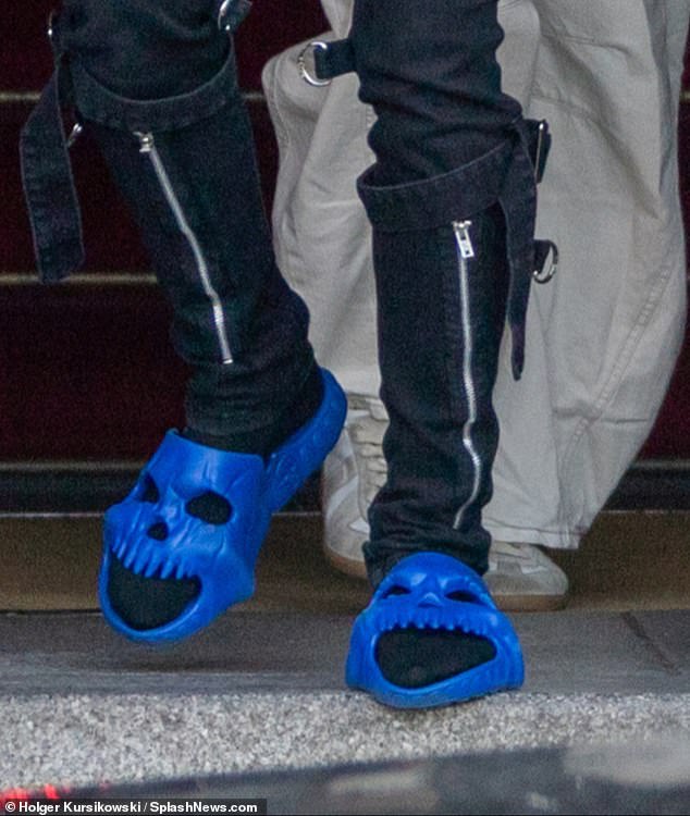 Unusual: Leto's blue skull sliders inevitably attracted attention as he walked outside the hotel on Berlin's Bebelplatz