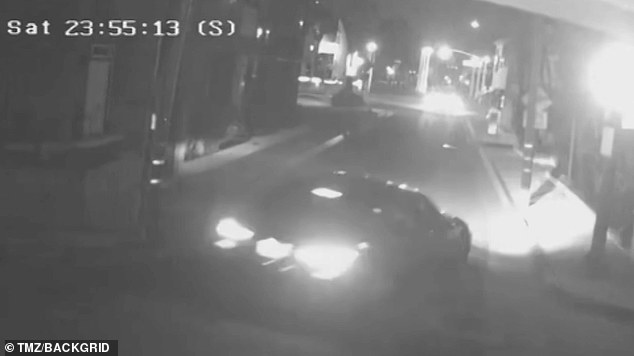 The wild footage shows a car spinning out of control, crashing into a wall and then slowly reversing before speeding away