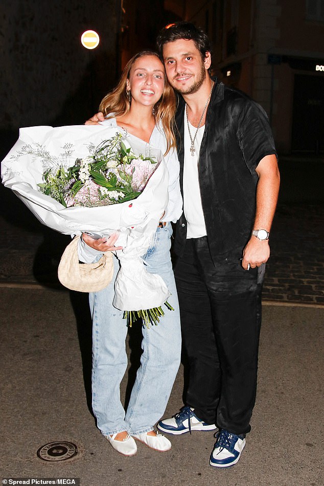 In love: David Ginola's daughter, 28, looked in good spirits as she was pictured holding a huge bouquet of flowers in her arms with fiancé Adrien Rosenpick