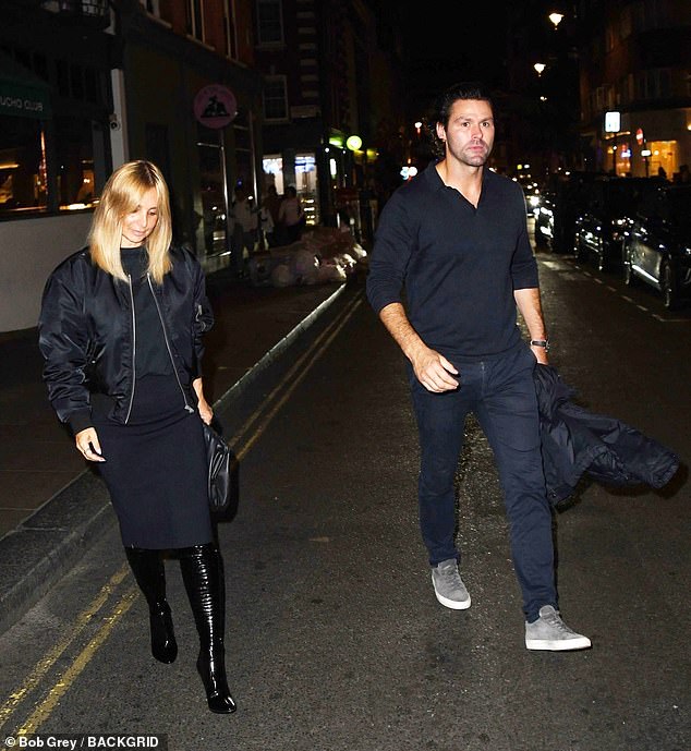 Moving on: Wearing a black bomber jacket, leather boots and matching skirt, Louise made her first appearance with a new man since her marriage ended.