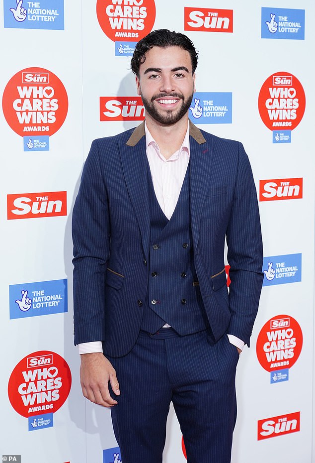 Dapper: Sammy looked incredibly stylish in a blue pinstripe suit with matching vest