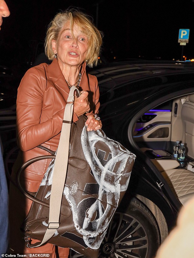 “Love” snake design: Sharon — who appeared to not wear makeup during her travels — also carried a personalized, darker brown “Di” tote bag, estimated to cost around $4,000.