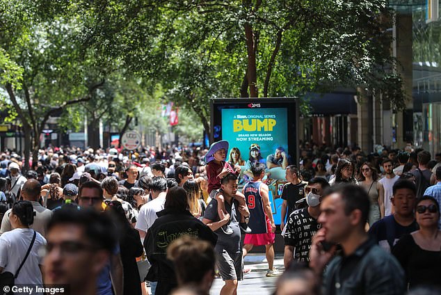 A record 454,400 migrants moved to Australia, on a net basis, in the year to March, despite a severe housing shortage in the country (pictured, Boxing Day crowds in the mall Pitt Street (Sydney)