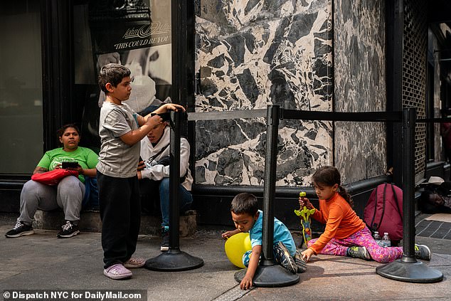 The city currently pays about $385 per night per migrant family that needs housing and food.  In the photo, migrant children are seen playing outside the Roosevelt Hotel.