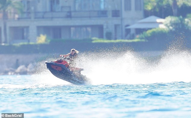 She rode confidently through the waves, sending a spray of salt water behind her.