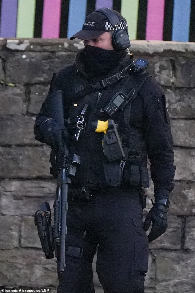 An officer at the scene could be seen holding a shotgun-style weapon at close range, with a handgun and a Taser in holsters.