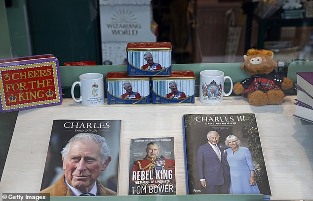 Books, mugs and a portrait depicting King Charles III are displayed in a shop window on the eve of the visit of the King and Queen of England on September 19, 2023 in Paris, France