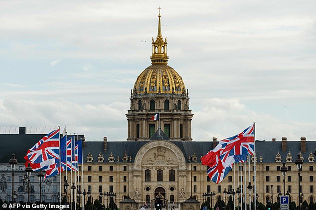 This photo taken on September 19, 2023 shows the French and British national flags in front of the Hôtel des Invalides in central Paris, as part of preparations for the upcoming visit of Britain's King Charles III and Queen Camilla to France .