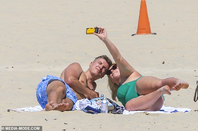 At one point, the lovebirds enjoyed some well-deserved rest on a beach towel and posed for loved-up selfies together.