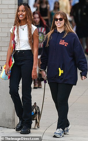 The Harvard grad, 25, seemed in good spirits as she accompanied a friend on a dog walk.