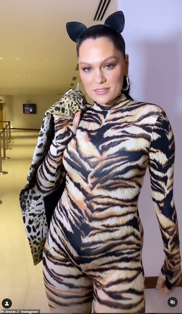 Work it out: In one look, she showed off her incredible postpartum figure in an animal print jumpsuit and ears as she strutted