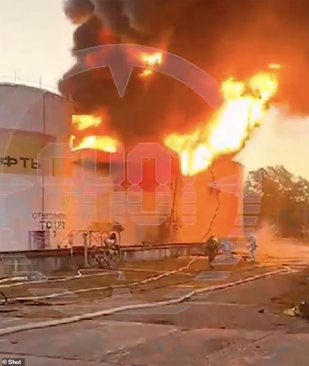 Rescue workers are seen working to put out the fire at the depot