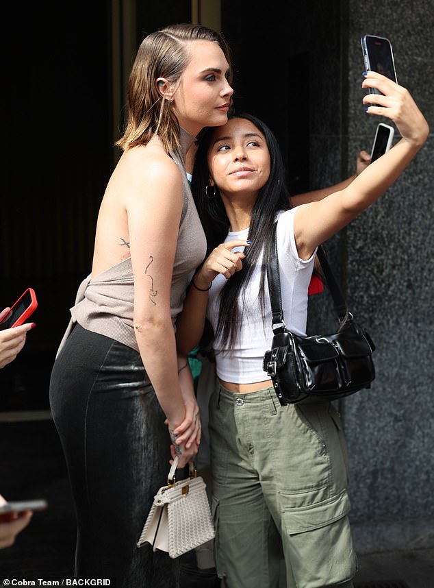 Selfies!  She was escorted by security out of her hotel and stopped to pose for selfies with fans waiting outside.