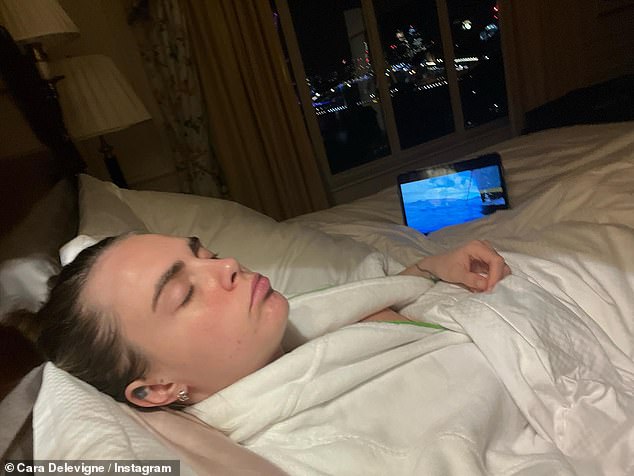 Relaxing: On Tuesday, Cara took to her Instagram and shared two snaps from her hotel bed in London while enjoying the view of the city.