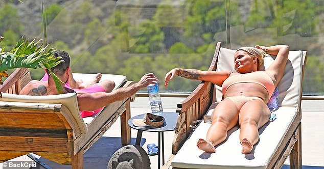 Quality time: After soaking up the sun, the former Atomic Kitten star turned her attention to Ryan, sharing a cheeky kiss and holding hands poolside.