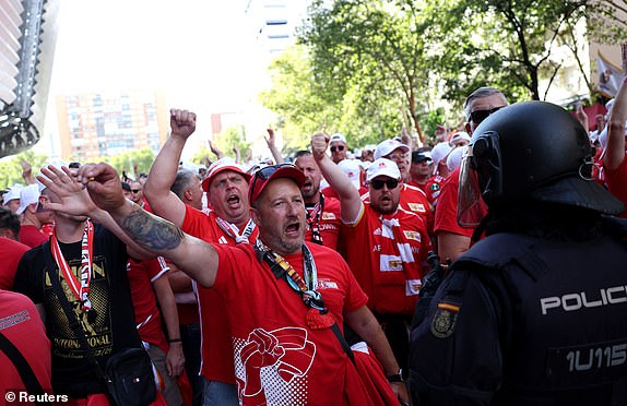 Soccer Football - Champions League - Group C - Real Madrid v 1. FC Union Berlin - Santiago Bernabeu, Madrid, Spain - September 20, 2023 1. FC Union Berlin fans next to a policeman outside the stadium before the match REUTERS/Isabel Infantes