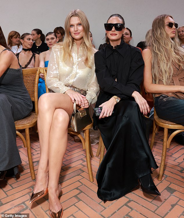 Pals: The duo was all smiles as they sat next to each other at the star-studded fashion show.