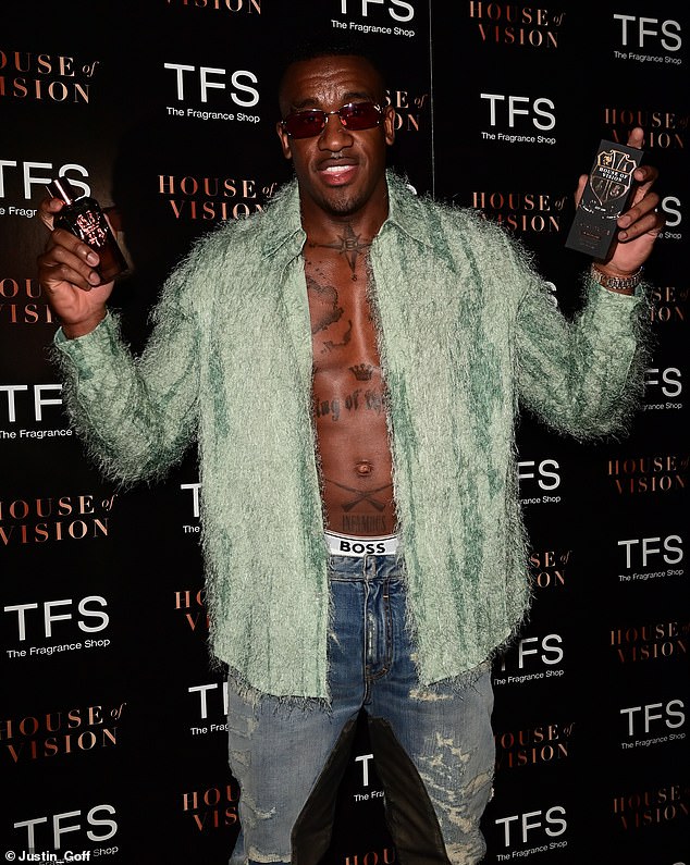 Star of the show: Bugzy, 32, was shirtless and showed off his washboard abs at the event and wore a huge silver chain necklace