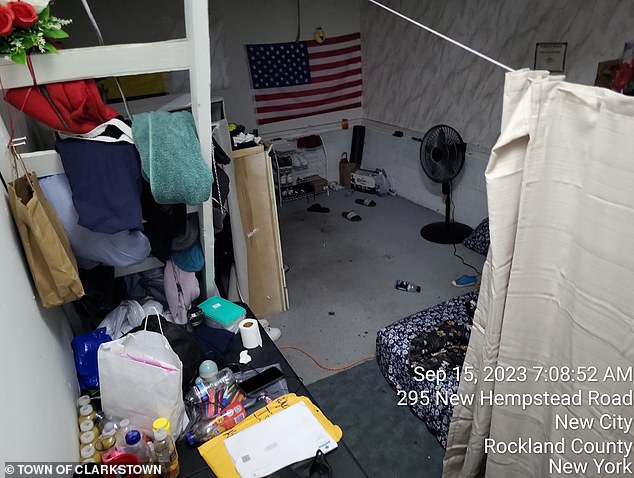 An American flag can be seen hanging in the dark garage, where shoes and beers can be seen scattered on the floor.