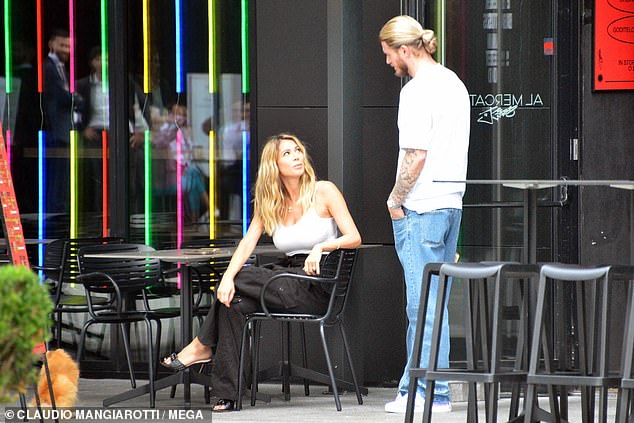 Cute: the couple, who took their dog for lunch, chatted outside the open-air restaurant