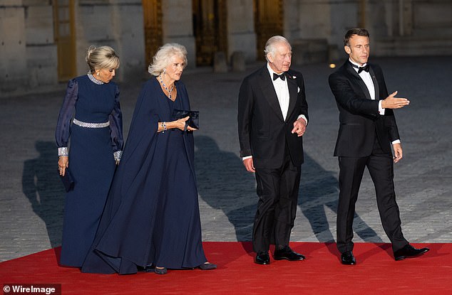 I assume the two talked ahead of time and coordinated nearly identical blue hues by the same designer as a show of togetherness.  From left: Brigitte Macron, Queen Camilla, King Charles III and President Emmanuel Macron attend a state banquet at the Palace of Versailles