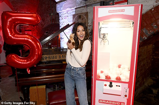 Happy: Michelle beamed in moments as she won a teddy bear from the entry machine at the event