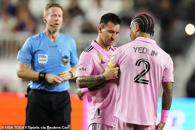 Messi hands the armband to DeAndre Yedlin as he leaves the field