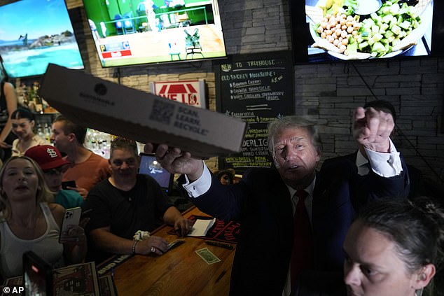 The former president, 77, was spotted handing out pizza to delighted fans at Kathy's Treehouse Pub & Eatery in Bettendorf.