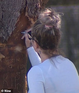 Dozens of mourners carved touching tributes for Berry into tree