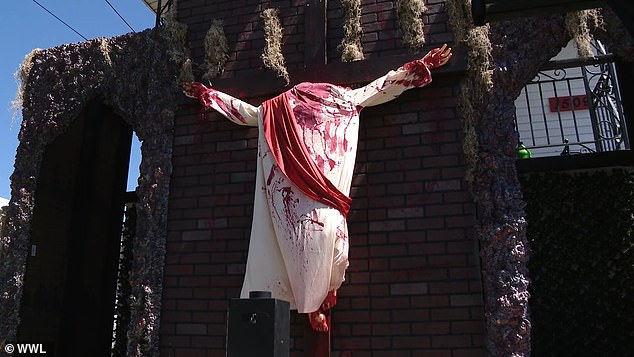 Below Satan is a crucifix from which the body of Jesus hangs.  Miorana said the exhibit does not reflect the family's personal or religious beliefs, but 