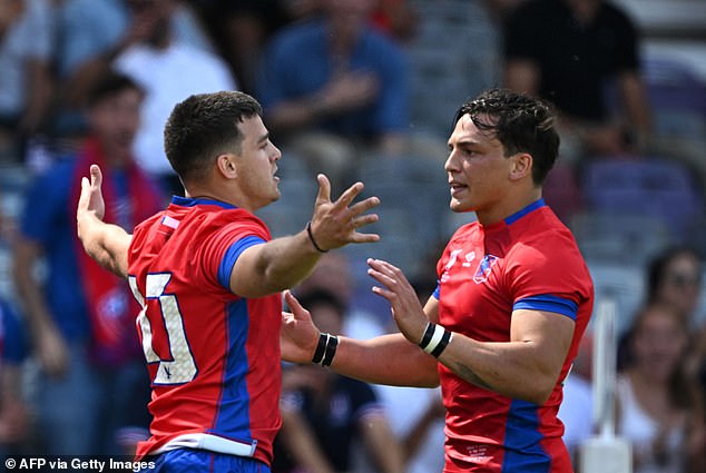 Chile fly-half Rodrigo Fernandez (left) celebrates scoring the first try against Japan