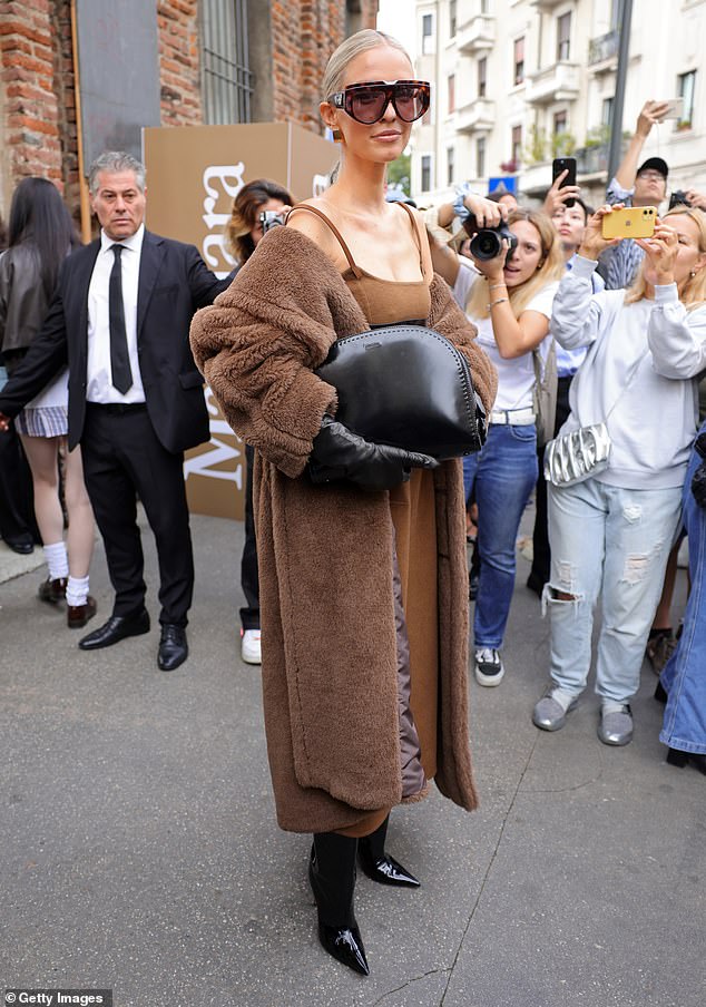 Cool: Leonie Hanne attracted attention in a brown wool midi dress that she combined with a long matching fur coat