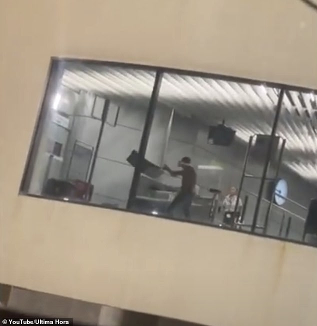 Video shows the topless man, who has not been named, throwing a bin against the wall before gesturing angrily at Ryanair staff who were hiding behind a glass door