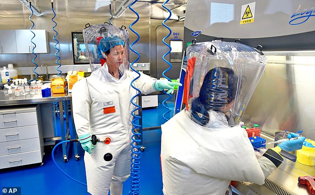 Virologist Shi Zheng-li, left, works with her colleague in the P4 lab of the Wuhan Institute of Virology in 2017.  Dr.  Li was among the recipients of an HHS notice about withdrawing funding, but she never responded to the agency.