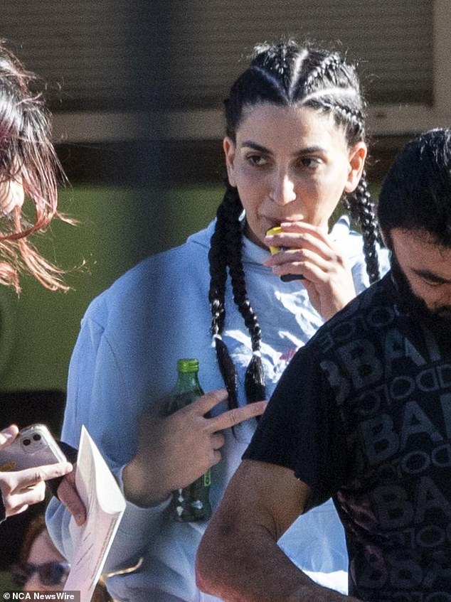 Susan Alameddine is seen inhaling a vape and holding a bottle of V Energy as she walked out of prison wearing a gray tracksuit with her hair in tight braids