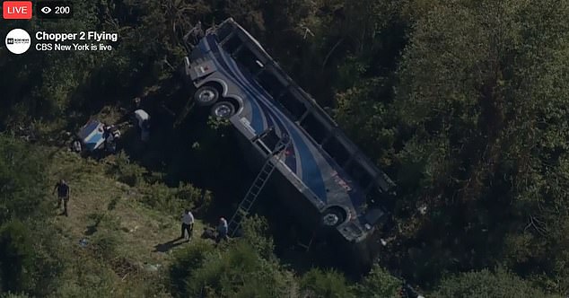 Ladders were lifted to the overturned bus to reach the passengers