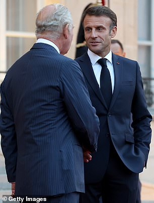 The king (pictured here with Emmanuel Macron) was due to visit France six months ago