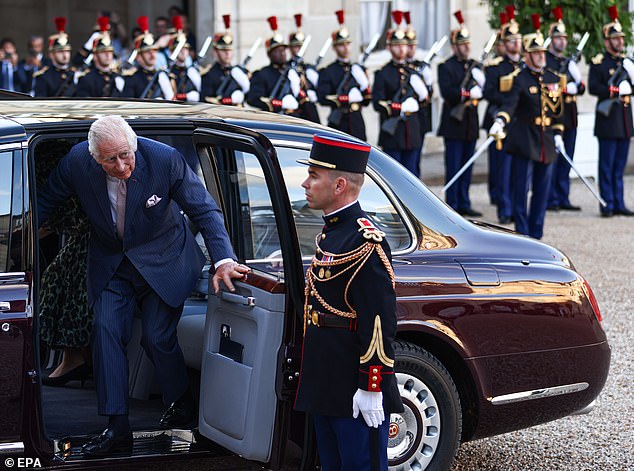 King Charles is snapped getting out of his car as he arrives at the Elysee Palace in Paris to meet the Macrons