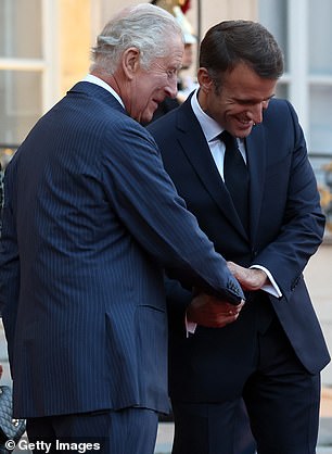 Macron greets King Charles (both in the photo)