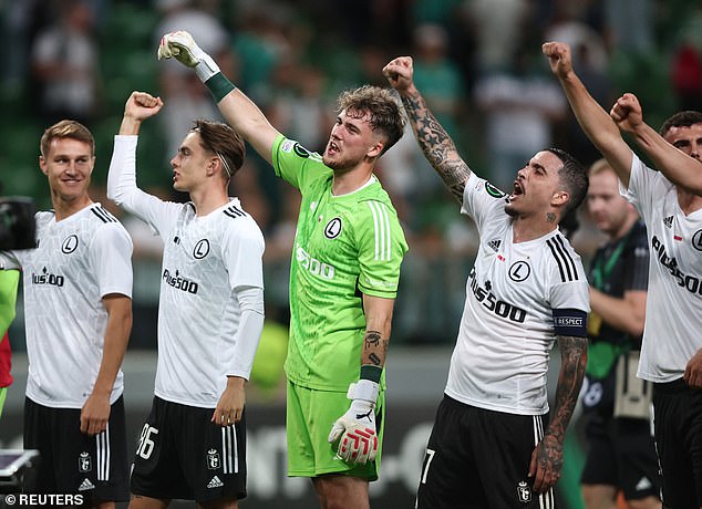 Legia Warsaw players celebrate their shock victory over Villa in the Europa Conference League