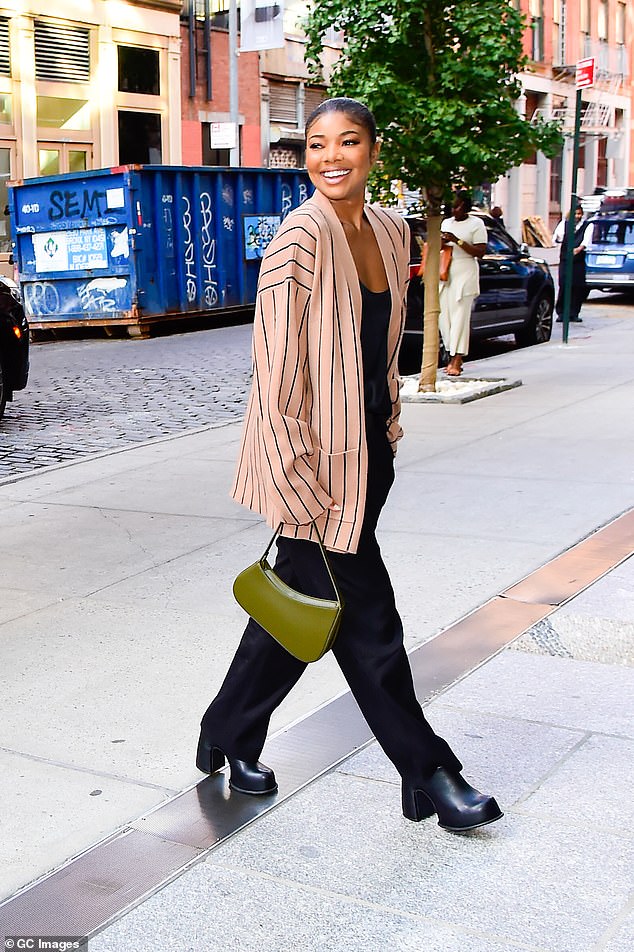 Afternoon look: During the afternoon outing, Union stepped out wearing a black $110 Banana Republic 'Sublime Silk Tank' under a pink scarf with black stripes