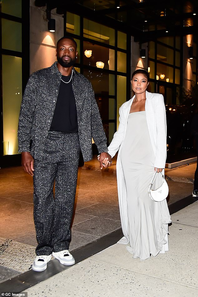 Dwyane's look: Her husband of nine years stepped out wearing a black t-shirt under a sparkly gray jacket and matching trousers