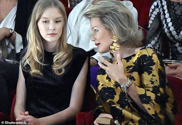 The 15-year-old (pictured, left) wore a chic all-black ensemble as she attended the event with her mother, Queen Mathilde (pictured, right)