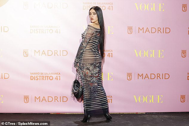 Hell for leather: Madonna's daughter carried a black leather bag with silver chain links to match her knee-high boots