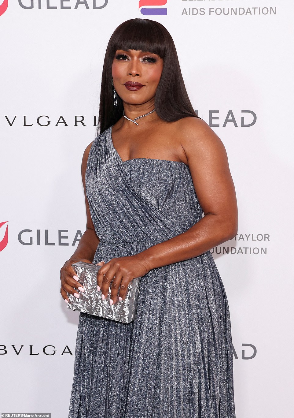 Darling!  Bassett looked banging in a long raven fringe wig and she sported a baby pink manicure for the Gilead Sciences and Bulgari-backed gala