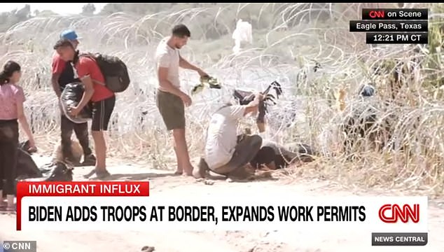 CNN's Ed Lavandera was live on air Thursday as migrants crawled under the barbed wire