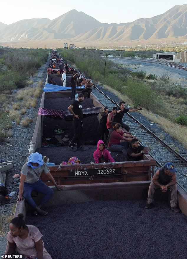 Migrants are seen in El Carmen, Mexico, traveling to the border on a train